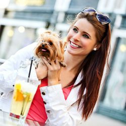 Woman enjoying a drink with her dog